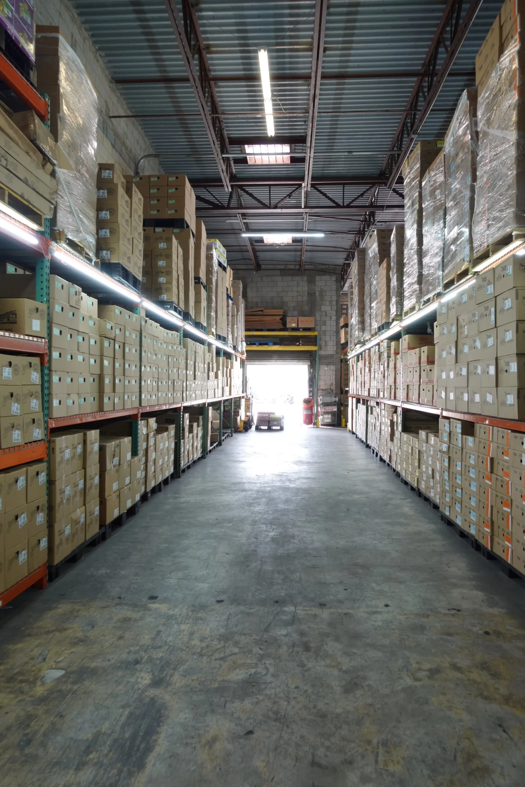 Riega Snacks warehouse aisle of racked snack cases leading to the loading dock